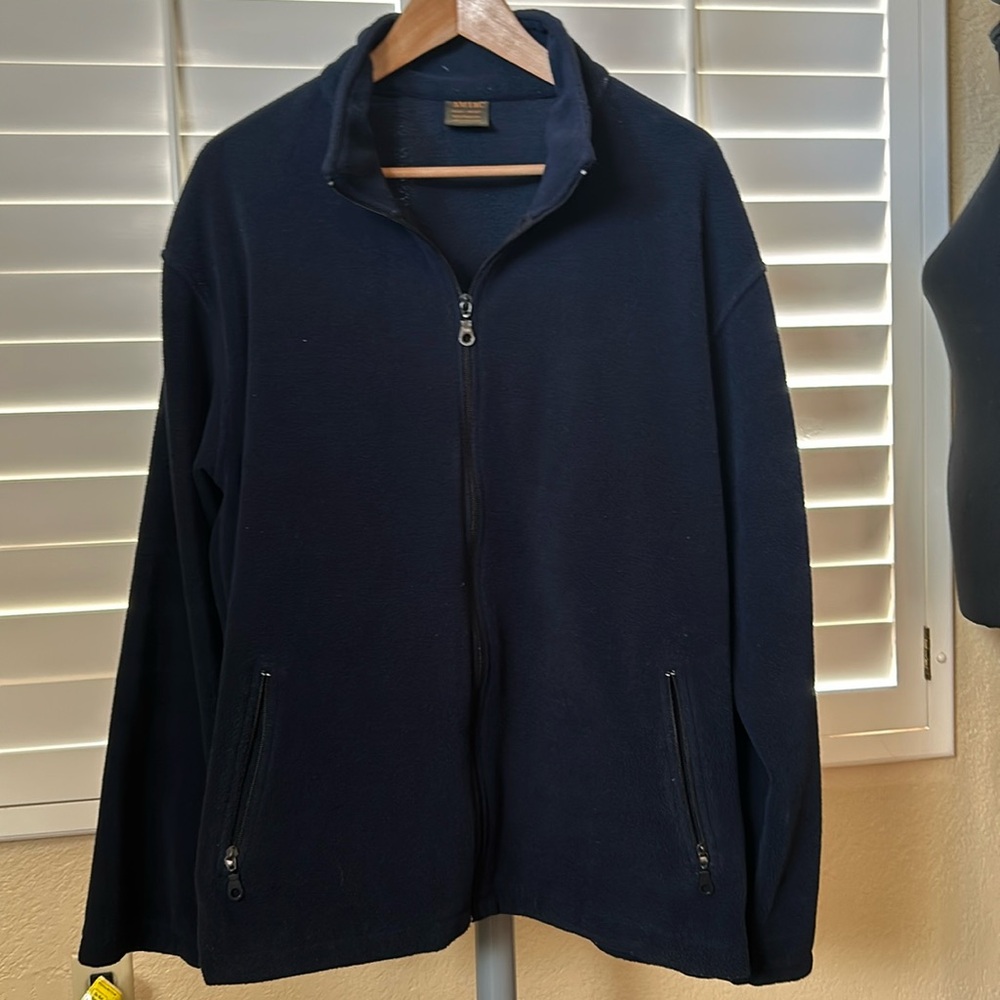 Blue men’s fleece jacket. Zippers in front ont and on sleeves. Light but warm XL
